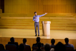 Male business executive giving a speech at conference center